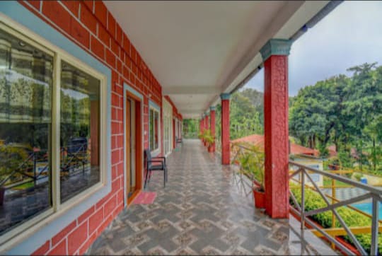 Upper floor balcony corridors with expansive views of Coorg landscape